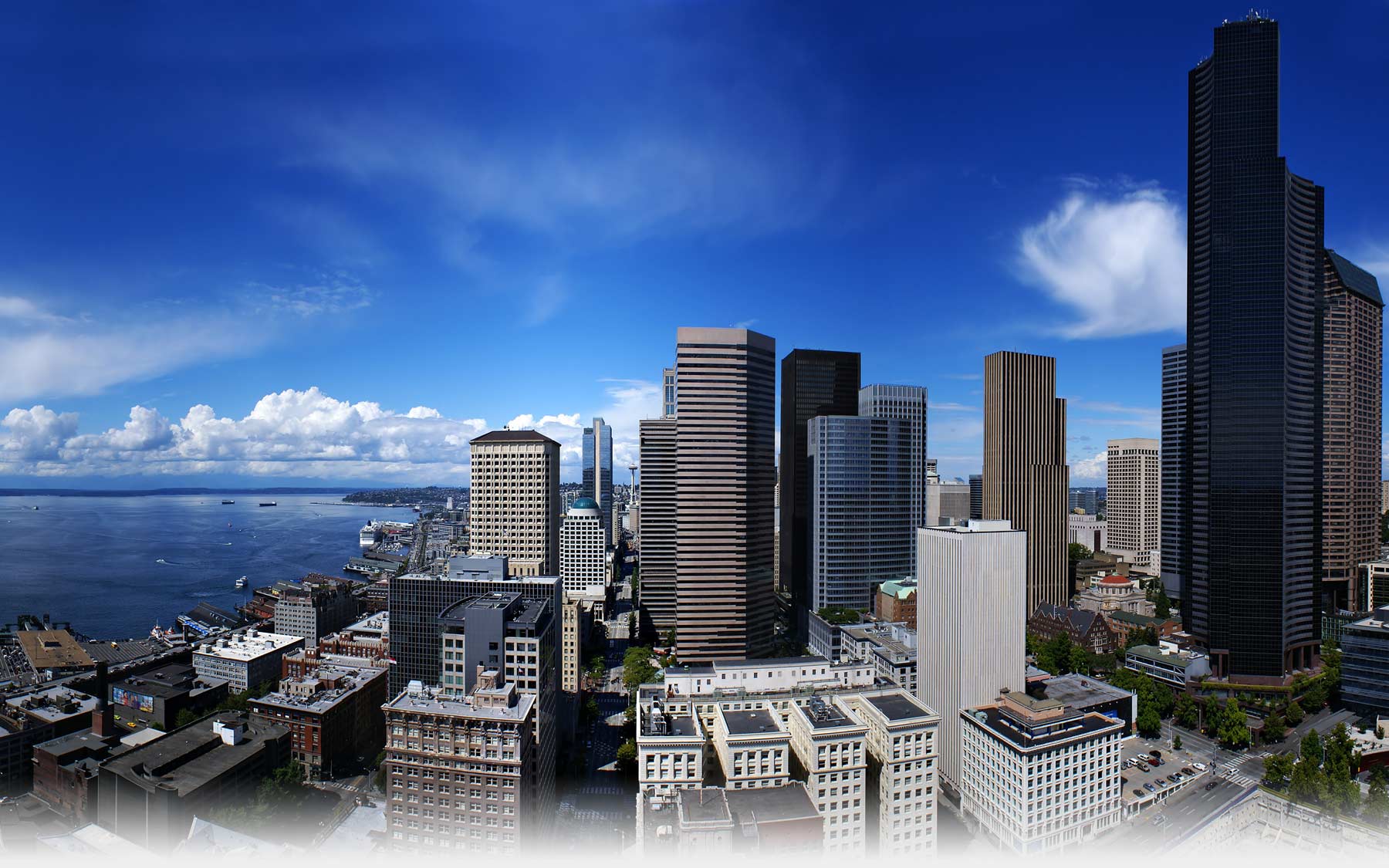 One-point perspective photograph of downtown Seattle, WA on a mostly sunny day